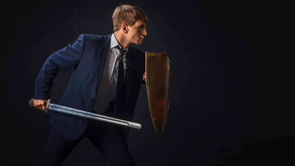 business person with shield and sword