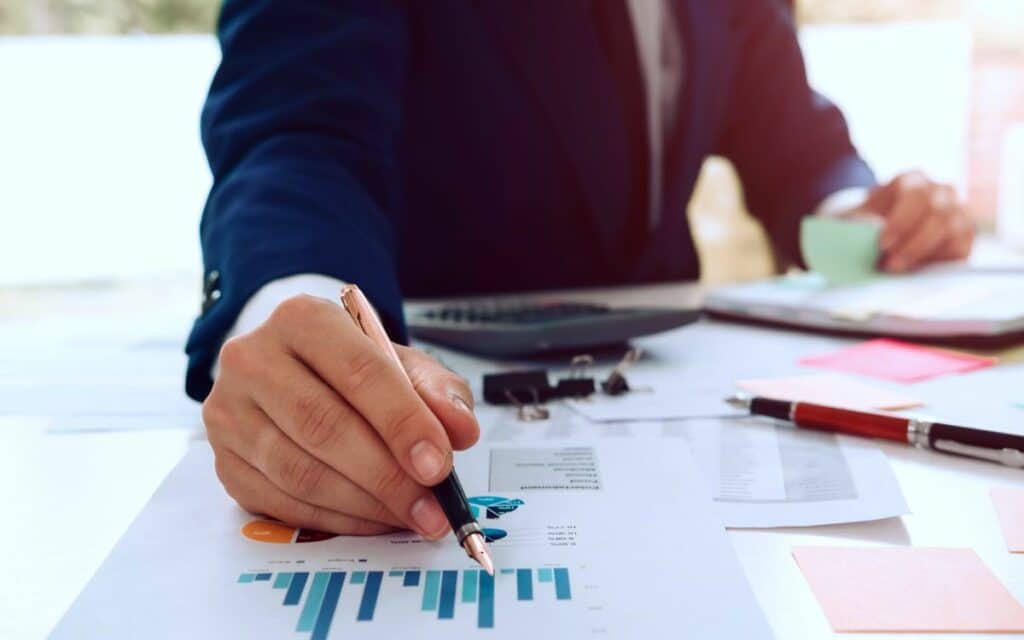 Person noting a data chart